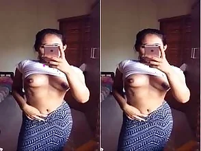 Pretty woman takes selfies of her big boobs to send to her lover.